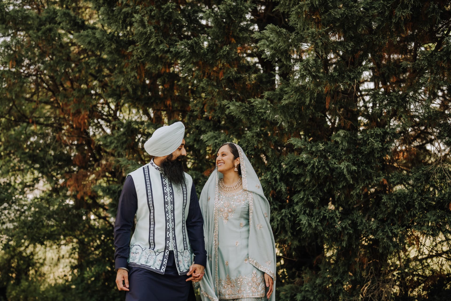 Savita and Gursean smiling at each other in traditional attire